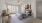 a bedroom with a bed and a table